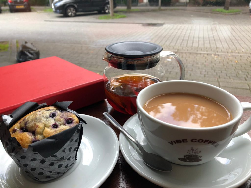 Vibe Coffee outdoor café scene with muffin and coffee